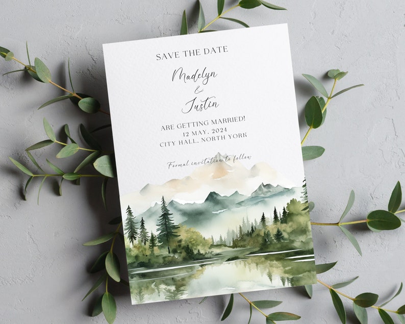 Puede incluir: Tarjeta de guardar la fecha con una ilustraci&oacute;n de acuarela de una cordillera, un lago y &aacute;rboles. El texto dice "Save the Date Madelyn & Justin Are Getting Married! 12 May, 2024 City Hall, North York Formal invitation to follow."