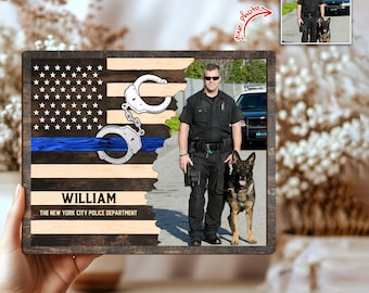 May include: Wooden plaque featuring an American flag design with a blue line and handcuffs. The plaque includes a photo of a police officer and a dog. The name "WILLIAM" and "THE NEW YORK CITY POLICE DEPARTMENT" are printed on the plaque.