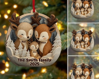 May include: A wooden Christmas ornament featuring a family of deer in a winter scene. The ornament has a red ribbon for hanging and includes the text "The Smith Family 2025". The deer are brown and beige with smiling faces.