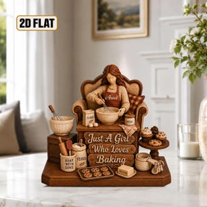 May include: A decorative figurine of a person named Anna sitting in a chair, mixing ingredients in a bowl. The base features the text "Just A Girl Who Loves Baking" and includes miniature baking accessories like flour bags, a whisk, cookies, and cupcakes.