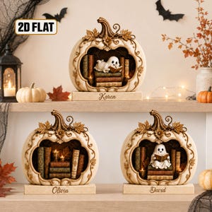 May include: Three cream-colored pumpkin-shaped ornaments with brown stems and leaf accents. Each features a hollow center containing a ghost figure reading a book among stacked vintage books. The bases are engraved with the names Karen, Olivia, and David.
