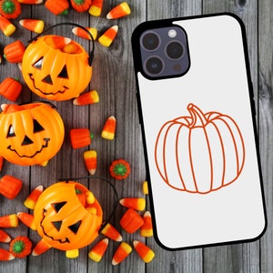 May include: A white iPhone case with a black outline and a pumpkin design. The pumpkin is orange and has a stem. The case has a black camera lens with three lenses.