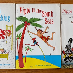 May include: Three vintage children's books with colorful illustrations. The titles are "Pippi Longstocking", "Pippi in the South Seas", and "Pippi Goes on Board" by Astrid Lindgren. The covers feature cartoon drawings of Pippi.