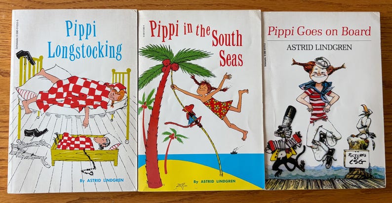 May include: Three vintage children's books with colorful illustrations. The titles are "Pippi Longstocking", "Pippi in the South Seas", and "Pippi Goes on Board" by Astrid Lindgren. The covers feature cartoon drawings of Pippi.