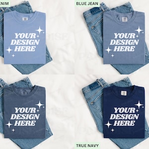 May include: Four blue t-shirts, each folded and placed on top of a pair of blue jeans. The shirts display the text "YOUR DESIGN HERE" in white. The colours are Washed Denim, Blue Jean, Denim, and True Navy. The jeans are a classic blue.