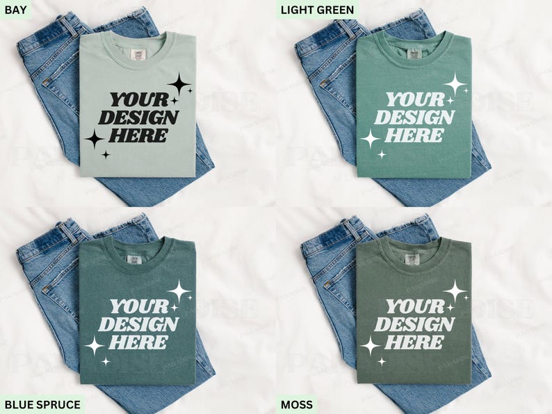 May include: Four t-shirts in various shades: bay, light green, blue spruce, and moss. Each shirt displays the text "YOUR DESIGN HERE" in white. The shirts are placed on blue denim jeans.