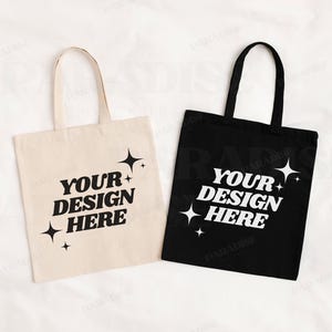 May include: Two tote bags, one white and one black, with the text "Your Design Here" and a star design.