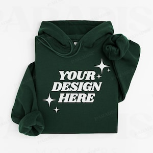 May include: A dark green hoodie with a white print that says "YOUR DESIGN HERE" and stars. The hoodie is folded and laid flat on a white surface.