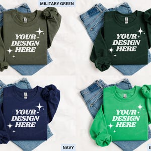 May include: Four crewneck sweatshirts in military green, forest green, navy, and Irish green, each with the text "YOUR DESIGN HERE" in white. The sweatshirts are displayed on top of blue jeans.