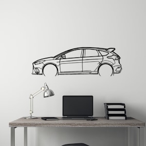 May include: A black metal wall art piece depicting the side profile of a car. The car outline is mounted on a white wall above a desk with a laptop, lamp, and office supplies. The car has a spoiler and hatchback design.