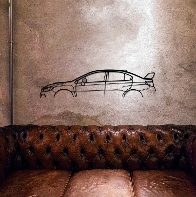 May include: A black metal car outline wall art piece. The artwork shows a side profile of a sedan with a spoiler. The car outline is mounted on a textured, light grey wall above a brown leather sofa.
