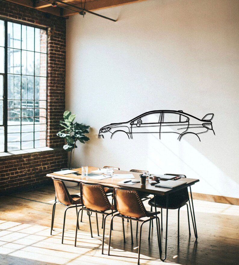 May include: A black metal car outline wall art. The car is a sedan with a spoiler. The art is mounted on a white wall in a room with a wooden table and chairs.