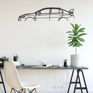 May include: A black metal car outline wall art. The artwork is mounted on a white wall above a desk. The desk has a white chair, a plant, and office supplies. The car outline is a modern, minimalist design.