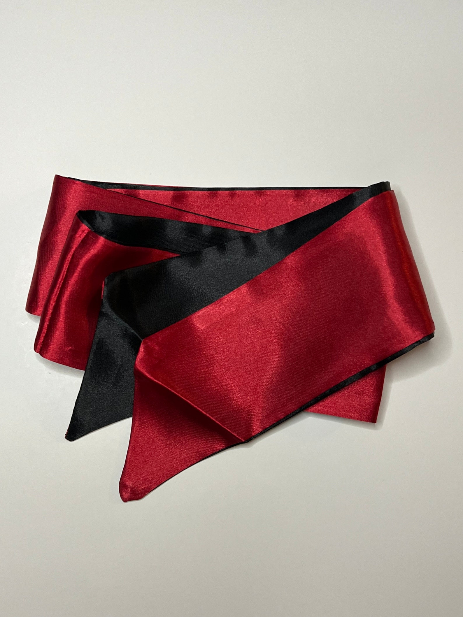 Erotic silk blindfold in red and black, perfect for beginner bondage and restraint sex