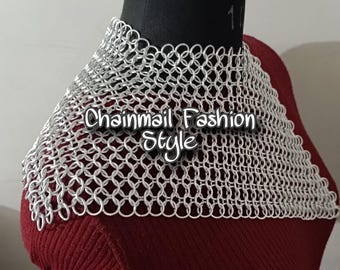 May include: A silver chainmail collar necklace on a red mannequin. The chainmail is made of small, interlocking metal rings. The text "Chainmail Fashion Style" is printed on the chainmail.