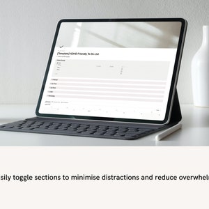ADHD digital planner displayed on laptop screen with clean, minimal workspace aesthetic.