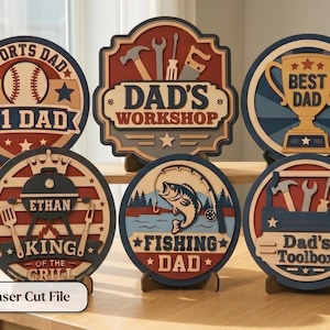 May include: A collection of laser-cut wooden signs with various themes. Designs include "Sports Dad," "Dad's Workshop," "Best Dad," "King of the Grill," "Fishing Dad," and "Dad's Toolbox." Each sign features a unique design and text.