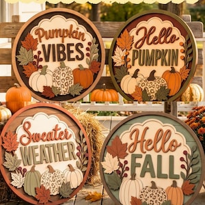 May include: Four circular wooden signs labeled PUMPKIN FALL SIGN COLLECTION. Each sign features layered cutouts of pumpkins, including leopard print patterns, and autumn leaves. The text reads Pumpkin VIBES, Hello PUMPKIN, Sweater WEATHER, and Hello FALL.