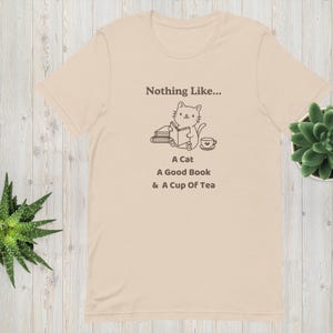 A Cat, A Book, A Cup of Tea T-shirt! Fun T-shirt! For Cat Lovers and Book Lovers! Soft Pink / Soft Cream Beige / White. Adult Sizes XS - 2XS