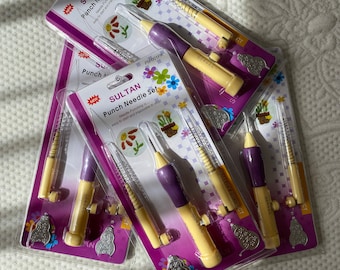May include: A set of four purple and yellow punch needle tools with a floral design on the packaging. The packaging says "SULTAN Punch Needle Set" and "PN-001PK".