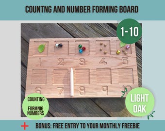 May include: Wooden counting and number forming board with 10 squares, each with a number from 1 to 10. The board is made of light oak and has a white chalk pencil. The board is used for counting and forming numbers.