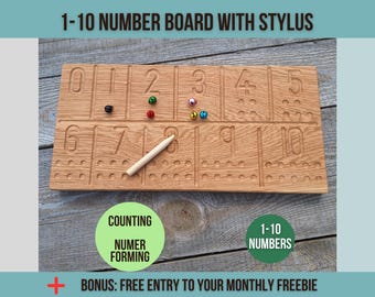 May include: A wooden 1-10 number board with a stylus. The board has carved numbers and corresponding dots. Colorful beads are placed on the board. The text "1-10 NUMBER BOARD WITH STYLUS", "COUNTING", "NUMBER FORMING", and "1-10 NUMBERS" are visible.