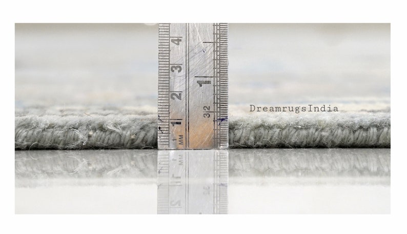 May include: Close-up of a gray rug with a ruler measuring the pile height at 1/2 inch. The text "DreamrugsIndia" is visible in the background.