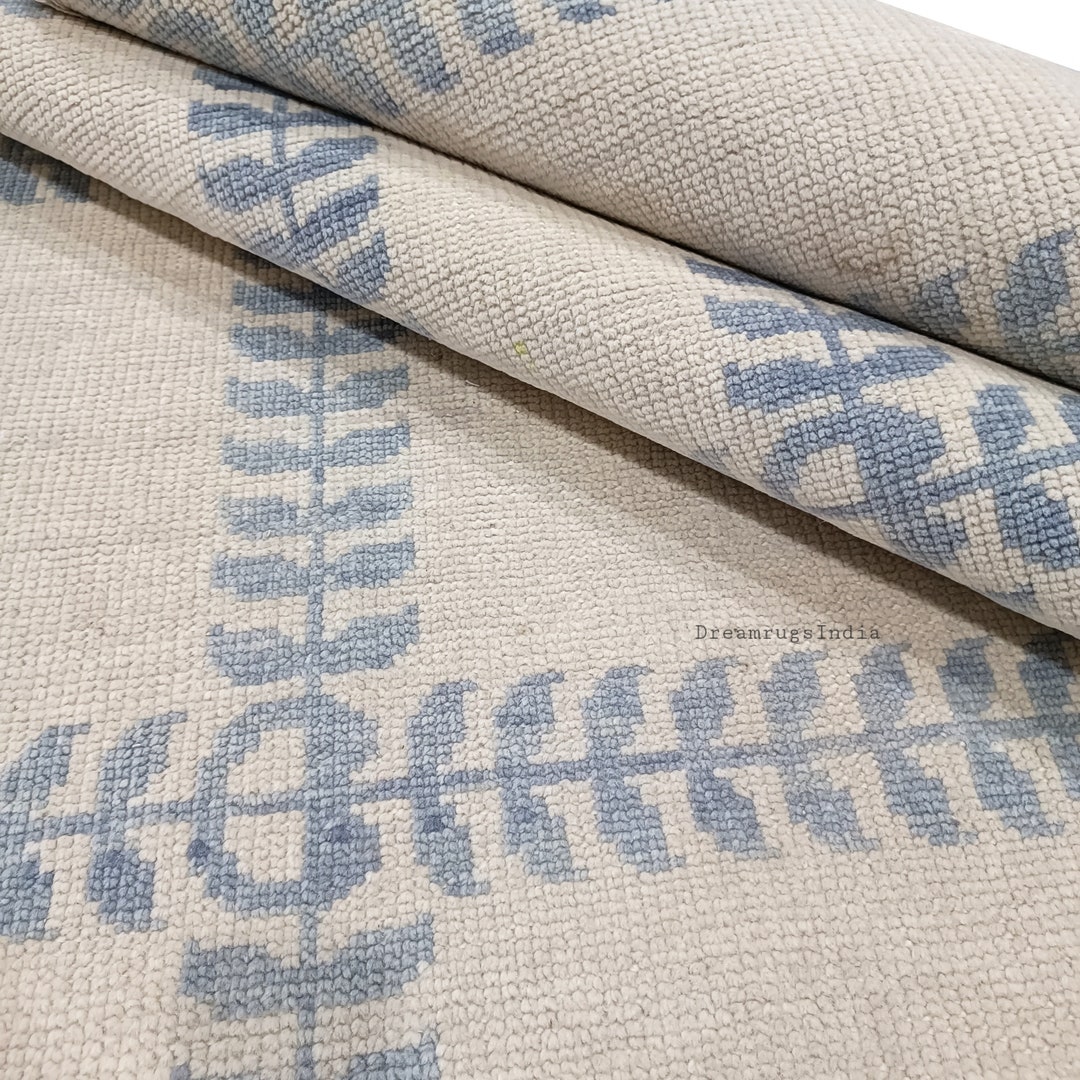 Pastel Cream Background and Blue Oushak Persian Knot Rug in Hand ...