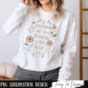 May include: White sweatshirt with a floral design and the text "BE TRANSFORMED BY THE RENEWING OF YOUR MIND" with the scripture reference "ROMANS 12:2".