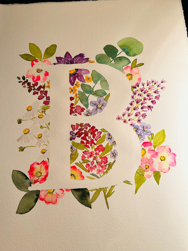 May include: Watercolour painting of the letter "B" created using a range of flowers and leaves in shades of pink, purple, white, and green.
