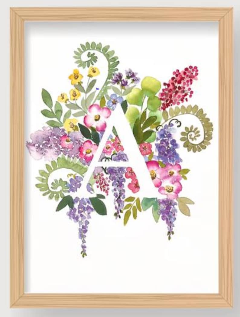 May include: Watercolor floral art print featuring the letter "A" in white, surrounded by a vibrant arrangement of pink, purple, yellow, and green flowers and foliage. The artwork is framed in a light brown wooden frame.