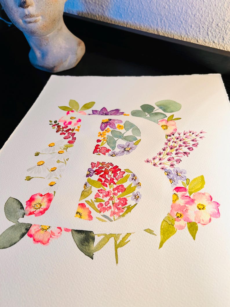 May include: A watercolour painting of the letter "R" formed from pink, white, purple and yellow flowers. The flowers are arranged to create the shape of the letter.