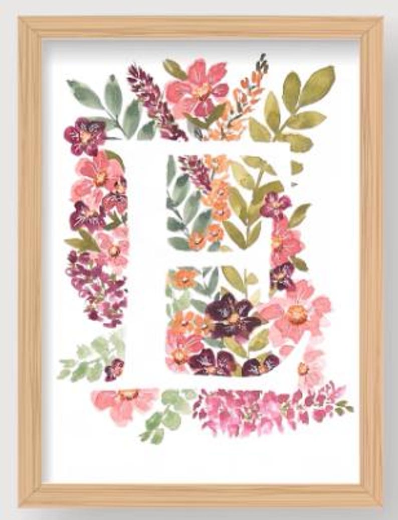 May include: Watercolor floral art print of the letter "E" in a wooden frame. The letter is filled with pink, purple, and orange flowers and green leaves. The frame is a light brown color.