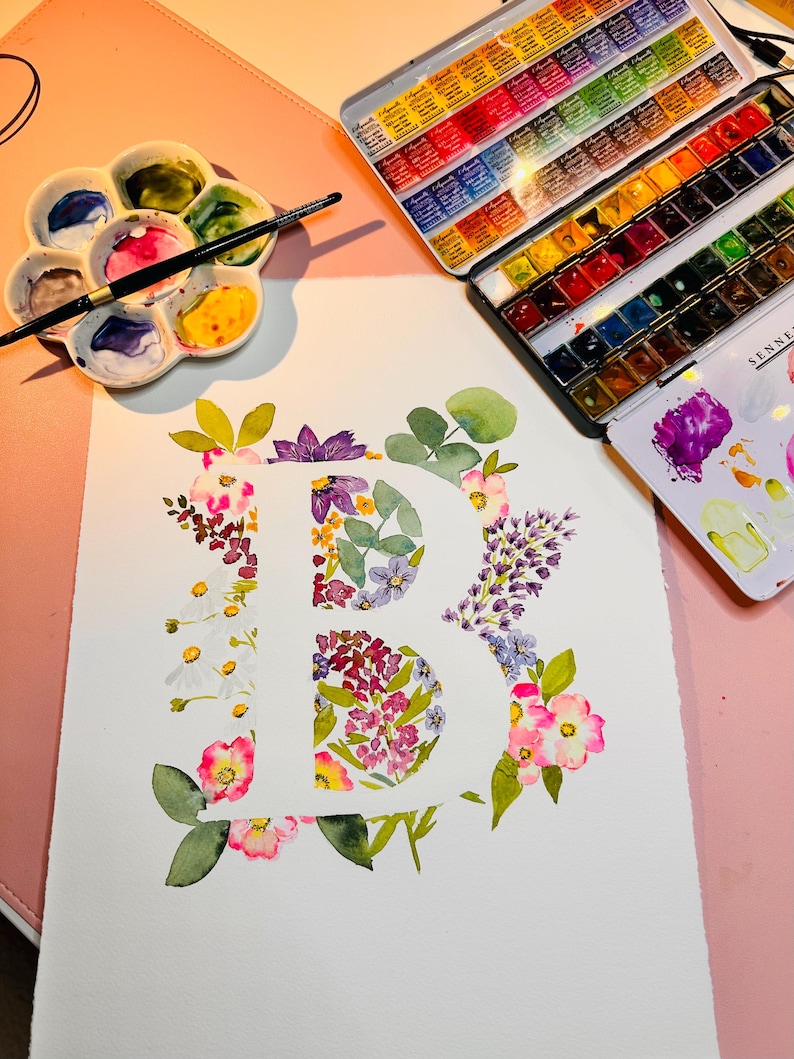 May include: A watercolour painting of the letter "B" created using a range of flowers in shades of pink, purple, white, and green.