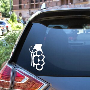 May include: White vinyl decal of a bear paw and claw design, applied to a car window. The graphic is a stylized representation of a bear's paw with visible claws, suitable for vehicle decoration.