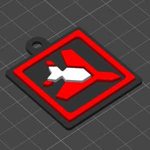 May include: A 3D-printed keychain with a red and white aeroplane design inside a red square frame, set against a black background. The keychain has a small loop for attachment. The design is geometric and modern.