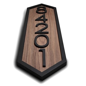 May include: A wooden house number sign with black numbers and a black hexagonal frame. The numbers are 12048.