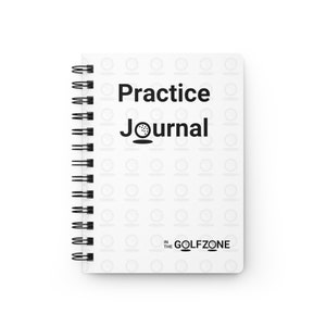 Op de afbeelding: Een wit notitieboek met spiraalbinding, een golfbalpatroon en de tekst "Practice Journal" en "In The Golfzone".