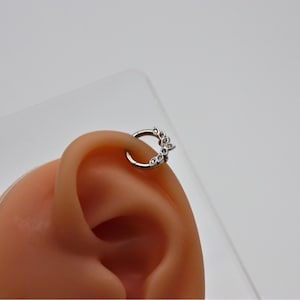 Elegant hoop piercing with flower motif – gold & silver, decorated with crystal stones