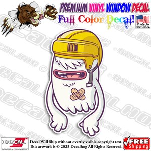 May include: A white cartoon monster wearing a yellow hockey helmet with a plaster on its face. The monster has a big smile and is wearing a black strap under its chin. The background is white.