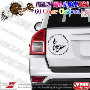 May include: A white car with a black and white butterfly vinyl decal on the back window. The decal is in a circle with the text "Custom Vinyl Decals" and "Your Design Any Size Any Shape".