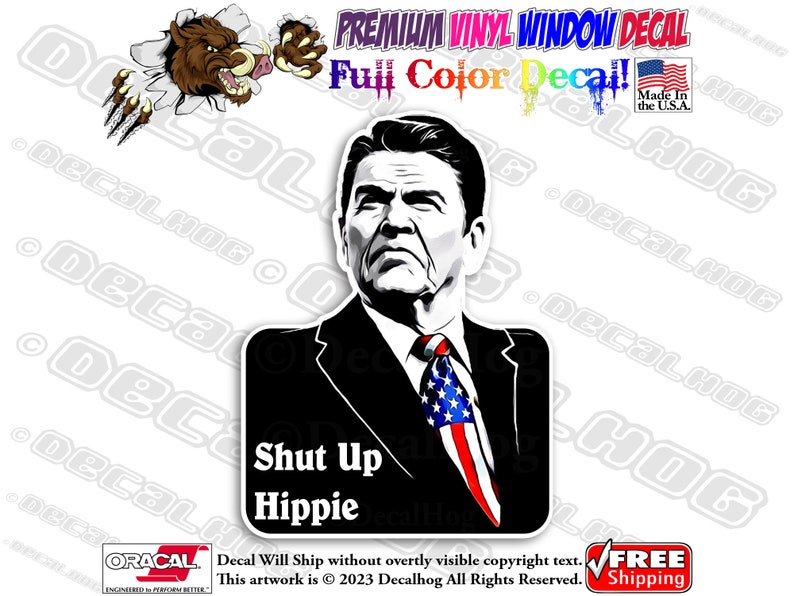 May include: A black and white illustration of a man with a serious expression. He is wearing a suit and tie with an American flag pattern. The text "Shut Up Hippie" is printed below the image.
