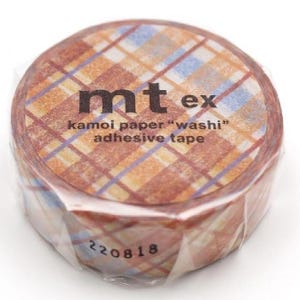 May include: A roll of mt ex kamoi paper "washi" adhesive tape. The tape features a plaid pattern in shades of brown, orange, and blue. The text "mt ex" is printed in black, along with the product details. The tape is wrapped in clear plastic.