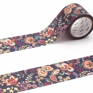 May include: Washi tape roll with a floral design in navy, peach, pink, and green. The tape has a repeating pattern of stylized flowers and leaves. The tape is unrolled, displaying the pattern. The roll has the 'mt' logo.