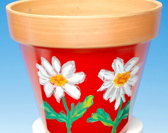 Hand painted & lacquered white daisy design on plastic flowerpot.  Now reduced buy 2 for 15 pounds