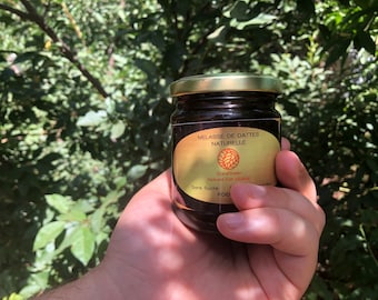 May include: A glass jar of dark brown date molasses with a gold lid. The label reads "Molasse de Dattes Naturelle" and "BioGreen Natural Pure Molasses".