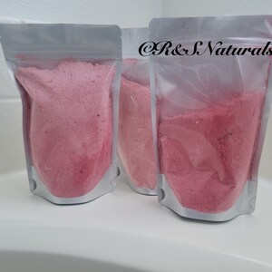 May include: Three clear plastic pouches filled with pink bath salts. The pouches are labeled "R&S Naturals".