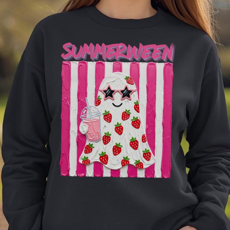 May include: Black sweatshirt featuring a white ghost with strawberry accents, star-shaped sunglasses, and a pink drink. The ghost is set against a pink and white striped background, with the word "SUMMERWEEN" in pink above.