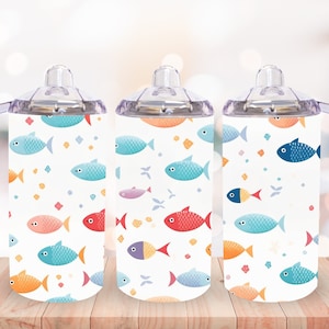 May include: Three clear plastic cups with handles and colorful fish designs. The cups have a white background with a repeating pattern of orange, blue, red, and yellow fish.