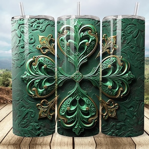 May include: Three stainless steel tumblers with a green and gold design. The design features a stylized floral pattern with intricate details.